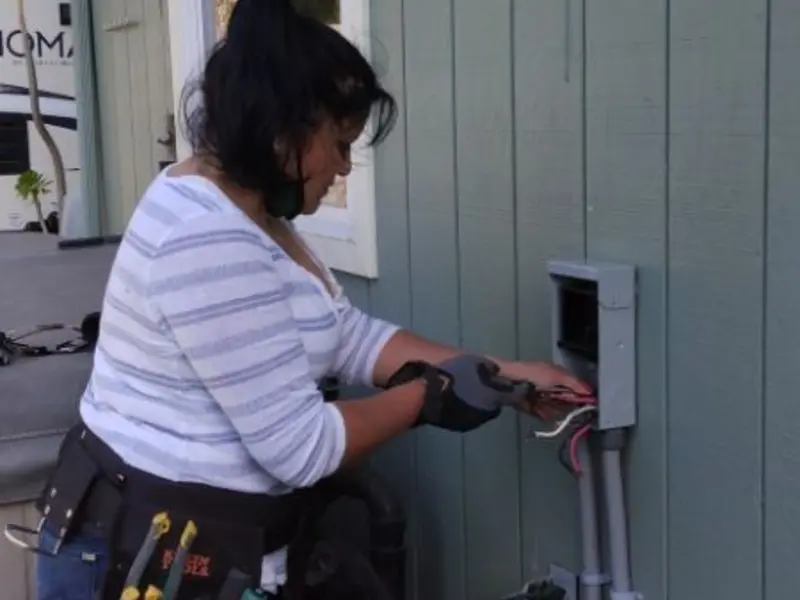 Licensed electrician wiring an exterior subpanel in Gravette